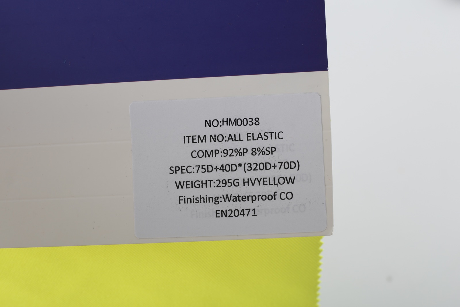 HM038 fluorescent-yellow sample card showing ALL ELASTIC, 92%P 8%SP and 295G